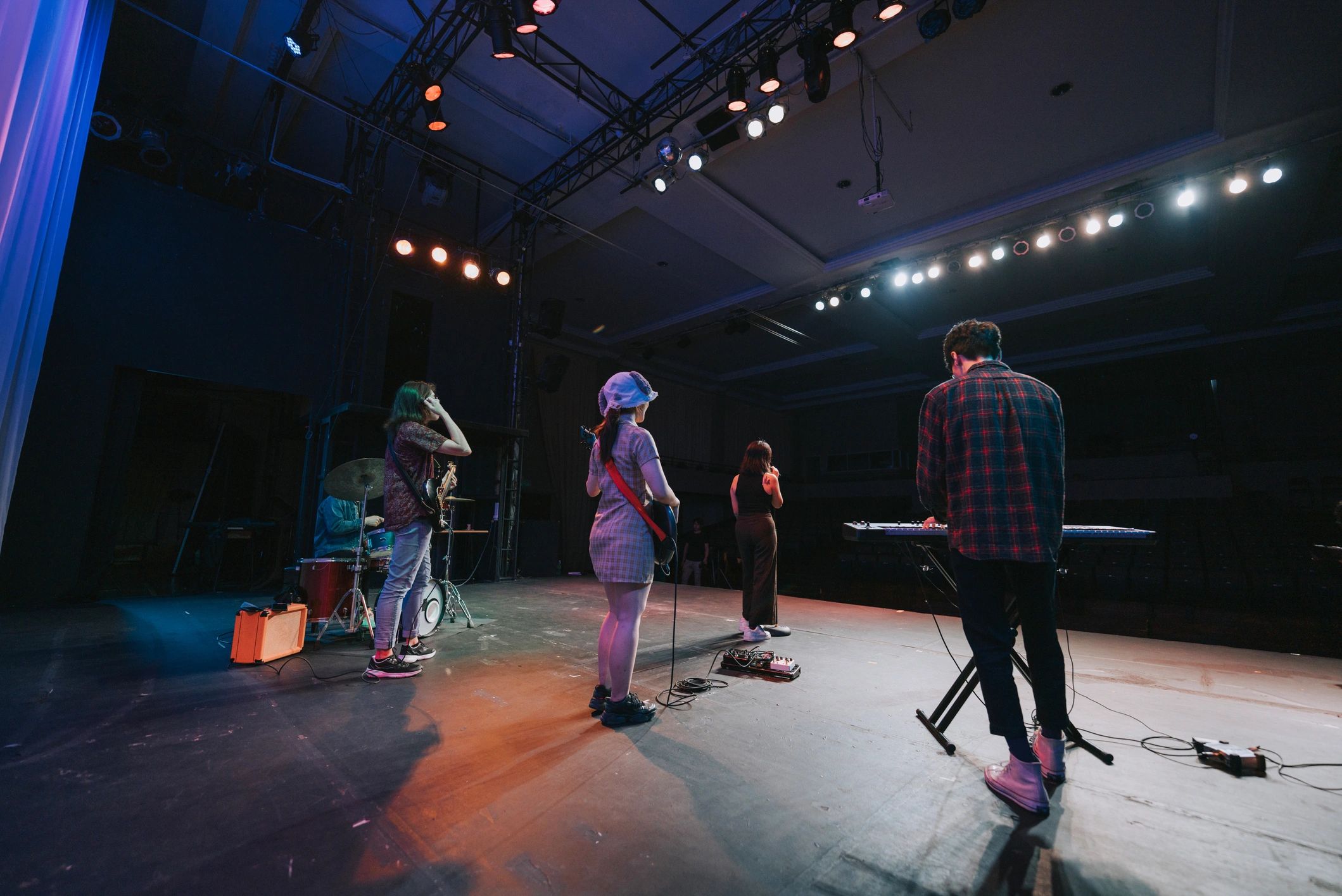 Young Asian chinese lead singer and live band Multiracial group performance on stage