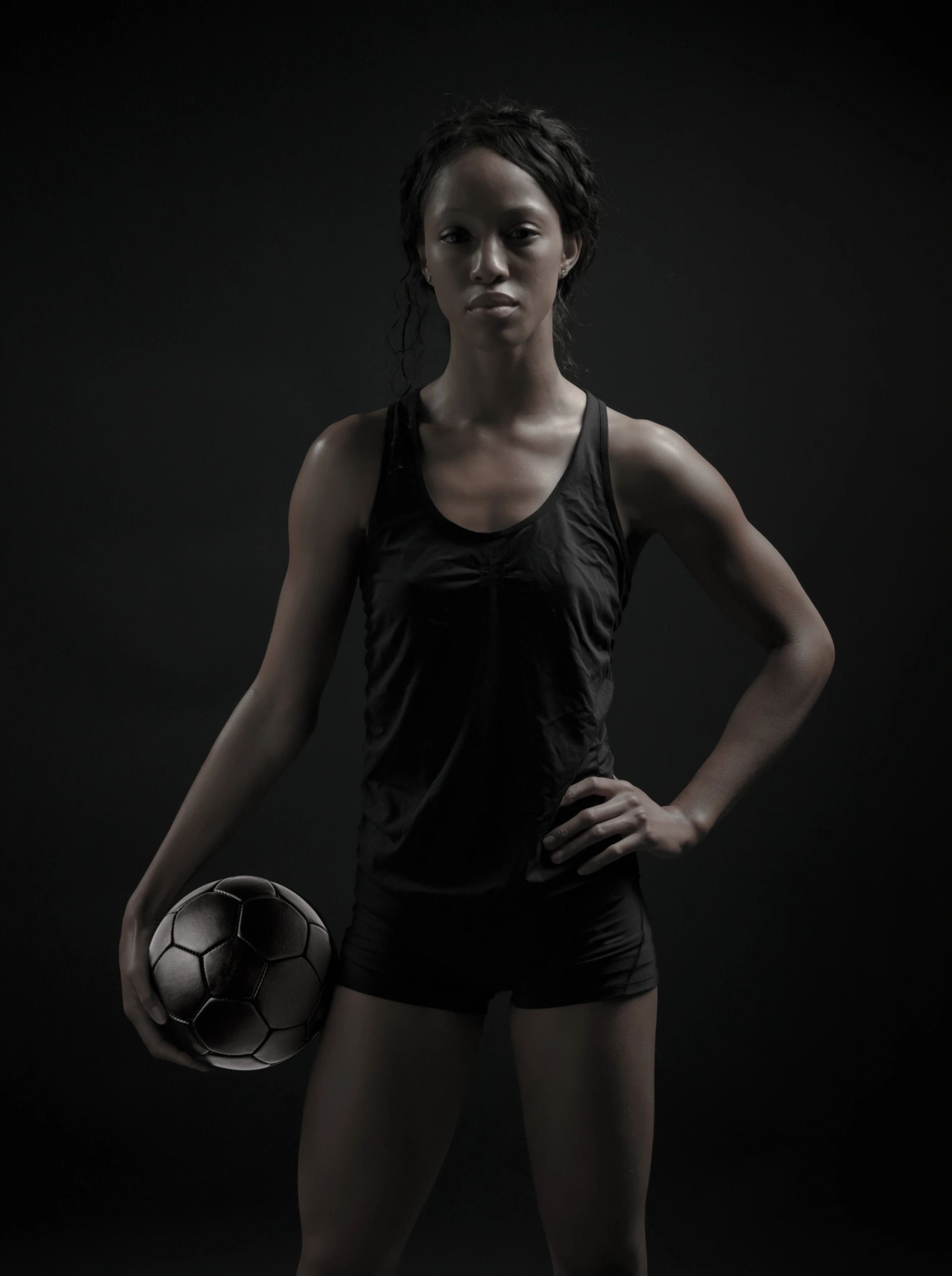 Female soccer player posing with ball